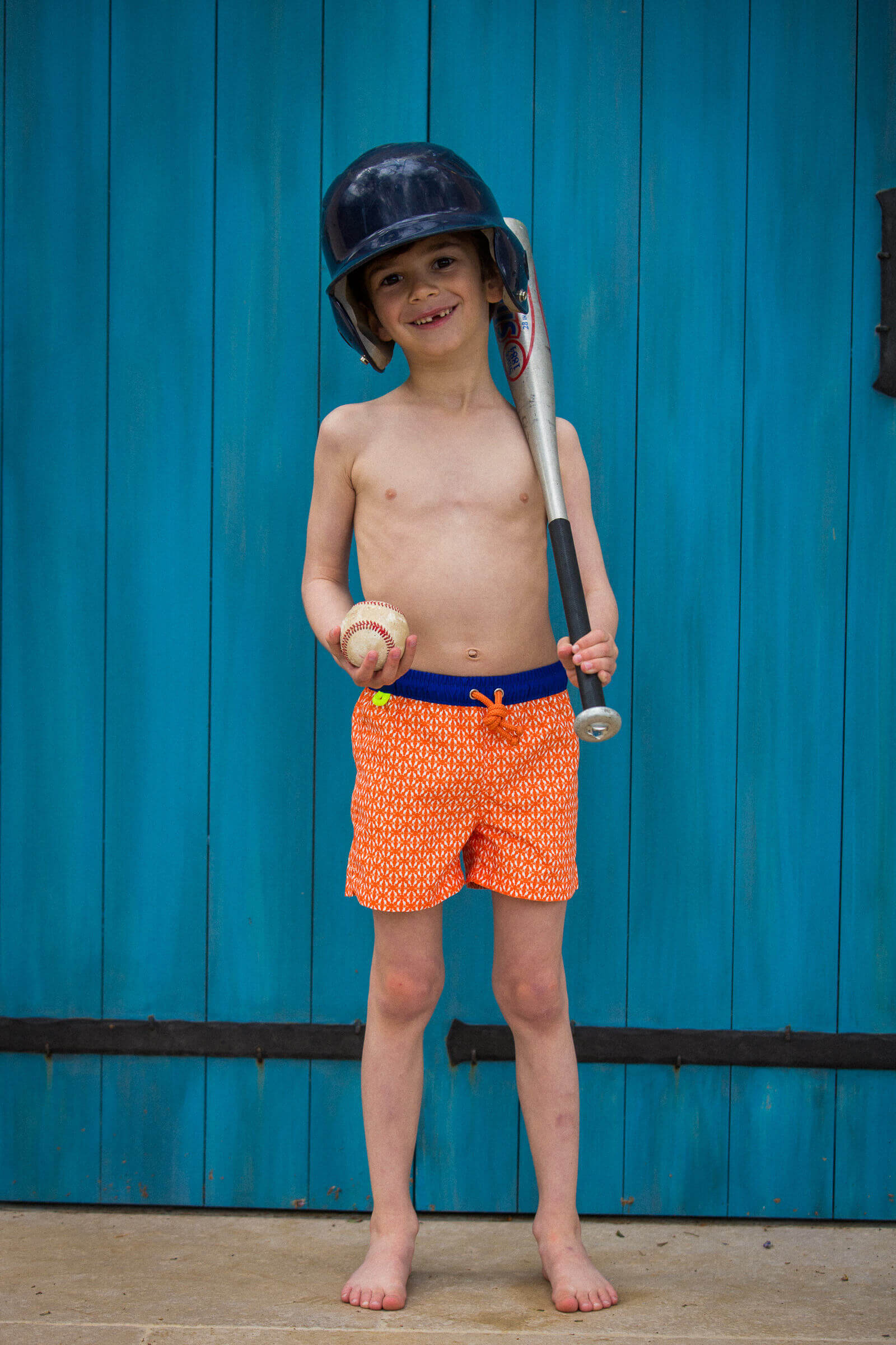 Boy wearing a swimsuit with elasticated belt orange Kangaroos