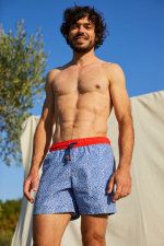 Man wearing a Off the Coast swimsuit with elasticated belt