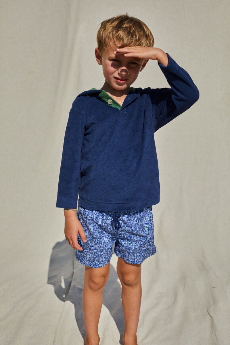 kid wearing a navy terry cloth sweat