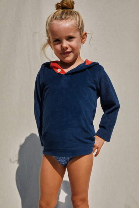 kid wearing a navy terry cloth sweat
