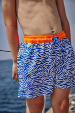 Boy wearing a swimsuit with buttoned belt Meno Electric Zebra